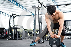 Muscular male having pain on shoulder in gym. young man injure