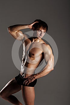 Muscular male model bodybuilder before training. Studio shot on