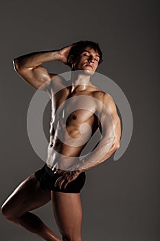 Muscular male model bodybuilder before training. Studio shot on