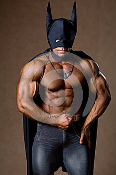 A muscular man in a Batman costume.