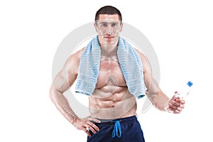 Muscular man with blue towel over neck, drinking water, isolated on white background