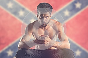 Muscular man with Confederate flag behind
