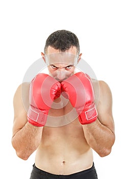 Muscular man with connected red boxing gloves near his face