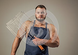 muscular man cook in chef apron hold barbecue grill, picnic