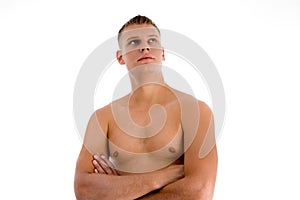 Muscular man with crossed arms looking upward