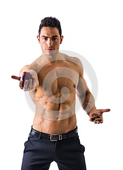 Muscular man deciding between healthy fruit and cookies