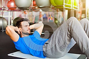 Muscular man doing abdominal crunches