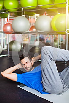 Muscular man doing abdominal crunches