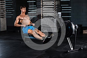 Muscular man doing exercise for legs in the gym