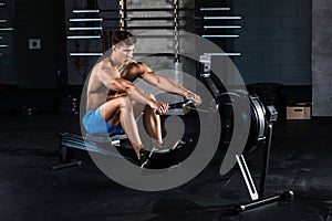 Muscular man doing exercise for legs in the gym