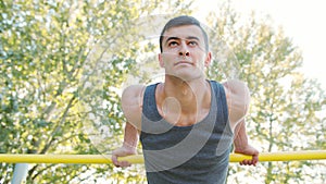 Muscular Man Doing Exercises on Horizontal Bar