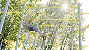 Muscular Man Doing Exercises on Horizontal Bar