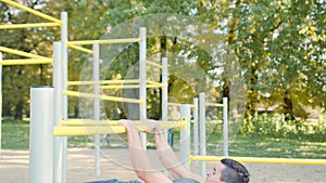 Muscular Man Doing Exercises on Horizontal Bar