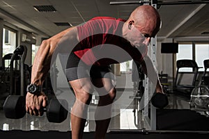 Muscular Man Doing Heavy Weight Exercise For Back