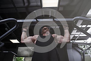 Muscular man doing pull ups