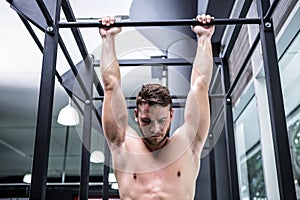 Muscular man doing pull ups