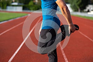 Muscular man doing stretching before jogging