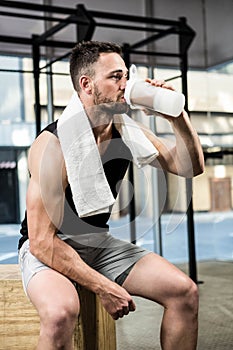Muscular man drinking protein shake