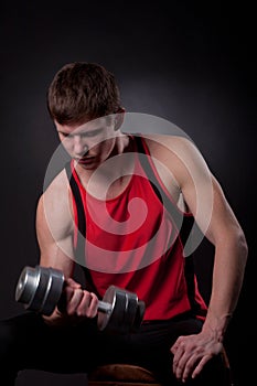 Muscular man with dumbbell