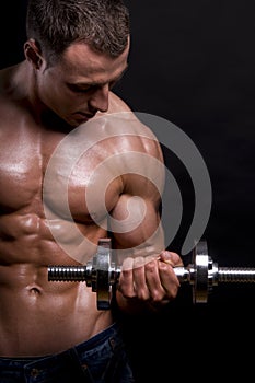 Muscular man with dumbbells.