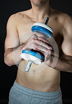 Muscular man with dumbbells