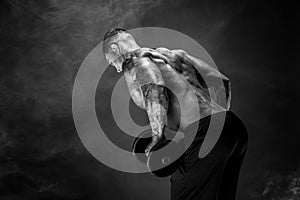 Muscular man with dumbbells doing exercises. Photo of strong male photo