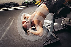 Muscular man exercising doing sit up exercise