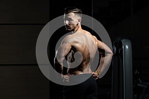 Muscular Man Flexing Back Muscles Pose