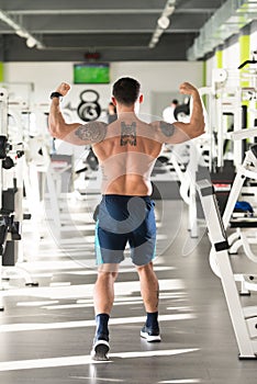 Muscular Man Flexing Back Muscles Pose