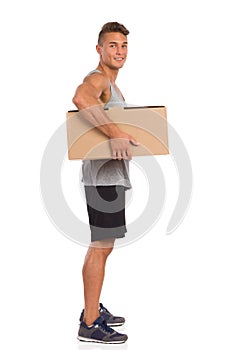 Muscular Man Holding Carton Box Under His Arm
