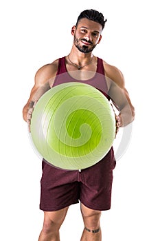 Muscular man holding inflatable fitness ball