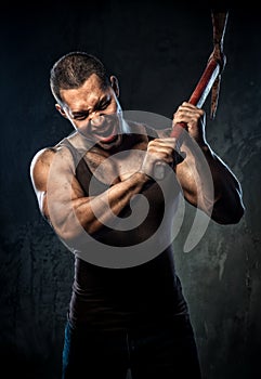 Muscular man holding pickaxe photo