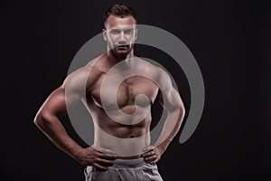 Muscular man isolated on black background