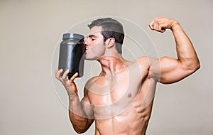 Muscular man kissing nutritional supplement