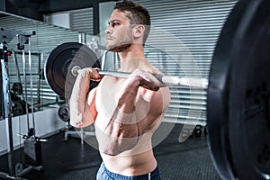 Muscular man lifting a barbell