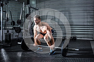 Muscular man lifting a barbell