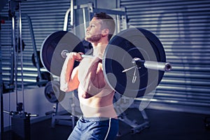 Muscular man lifting a barbell