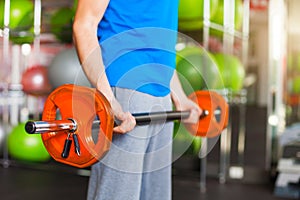 Muscular man lifting barbell