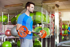 Muscular man lifting barbell