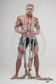 Muscular man with long rope