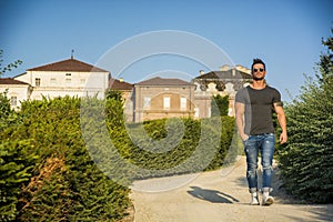 Muscular man in luxurious garden in Venaria, Italy