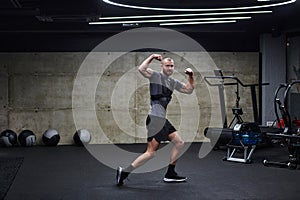 Muscular man posing in a modern gym