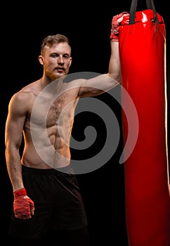 Muscular man with punching bag