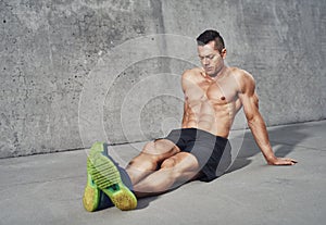 Muscular man relaxing after workout