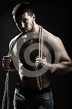 Muscular man with rope