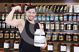 muscular man showing his biceps and holding pot