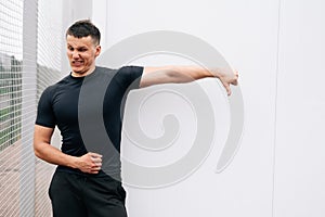 Muscular man shows thumb down. copy space for advertising