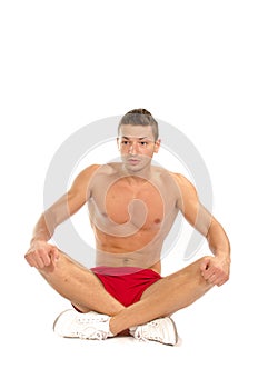 Muscular man sitting on the floor