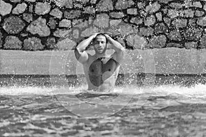 Muscular Man Standing Under A Water