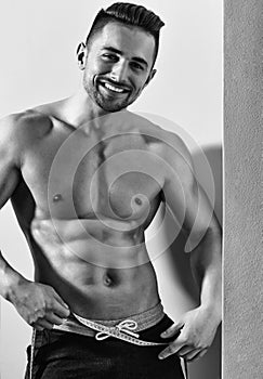 Muscular man with tape measure